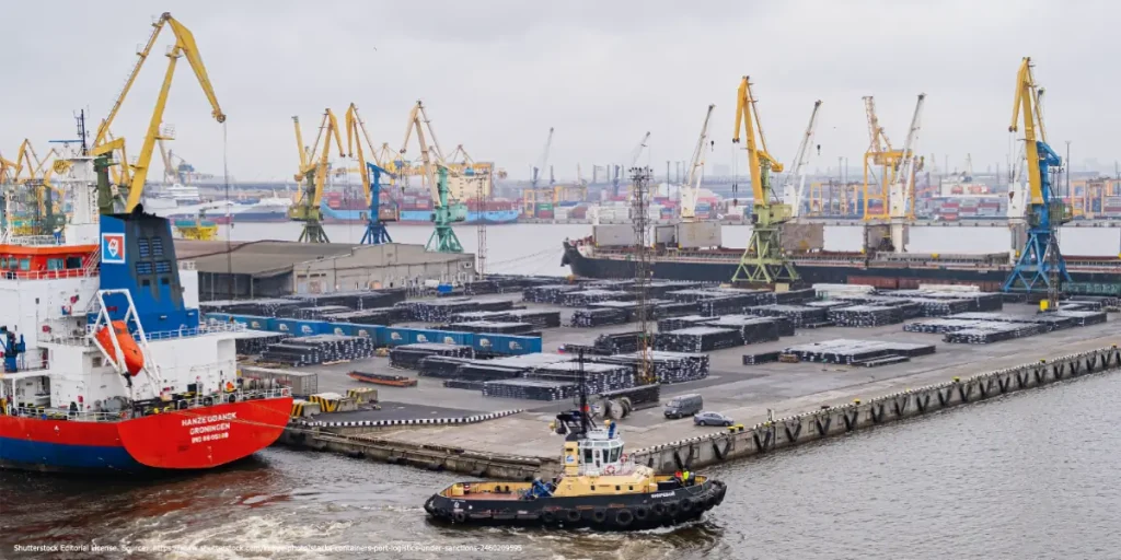 Cargo ships and cranes at a busy Russian port symbolizing international trade and the challenges of closing sanctions gaps against Russia.