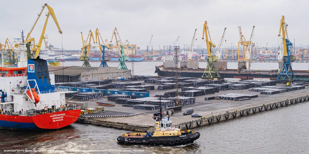 Cargo ships and cranes at a busy Russian port symbolizing international trade and the challenges of closing sanctions gaps against Russia.