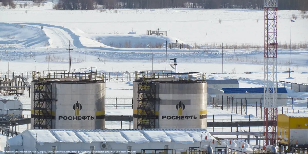 Rosneft oil storage tanks in a snowy industrial area, illustrating Russia’s budget strain due to dependence on oil revenues.