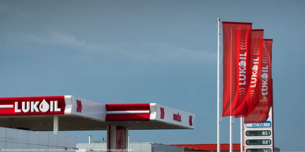 Lukoil gas station and branded flags shown amid U.S. sanctions Russian oil giants affecting the global energy market.