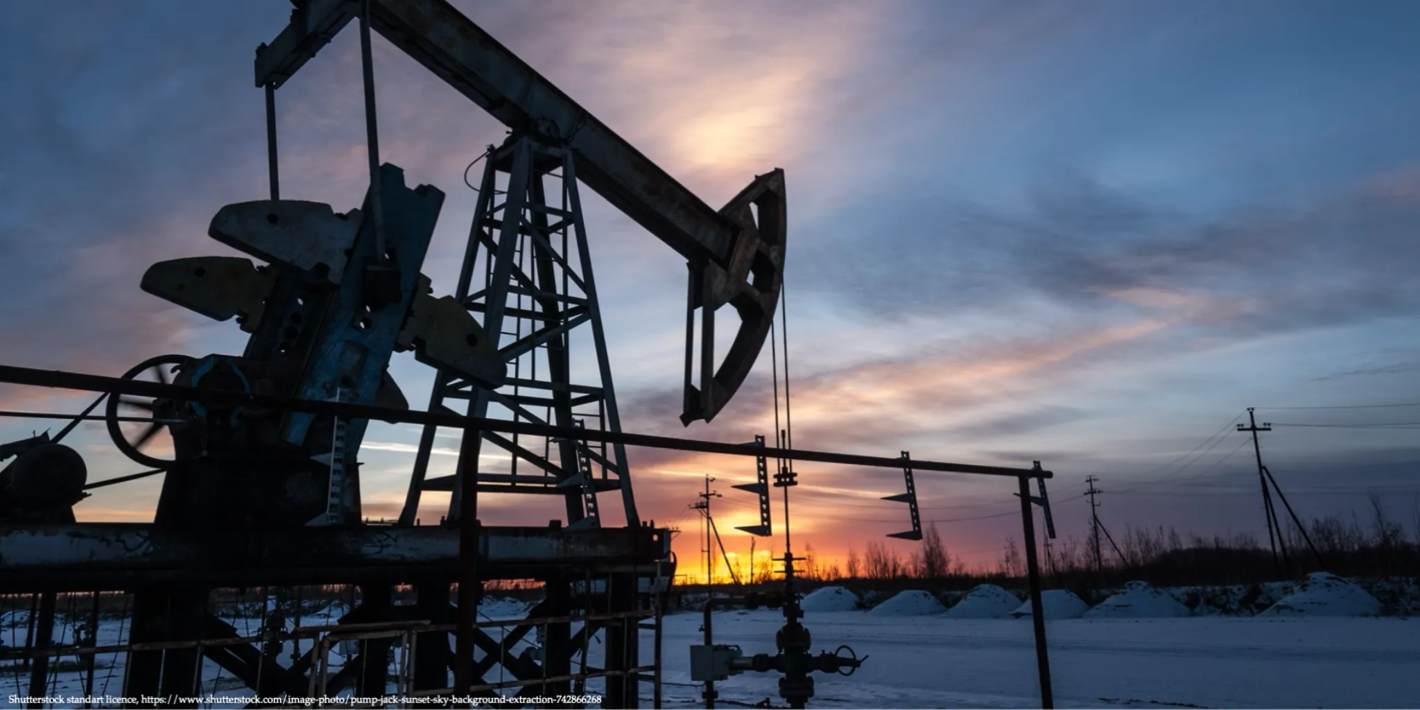 Oil pumpjack operating at sunset in a snowy field illustrating Russia's oil prices and constraints.