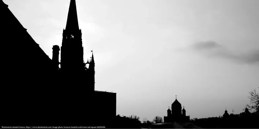 Silhouette of Kremlin towers and a cathedral skyline in Moscow at dusk.