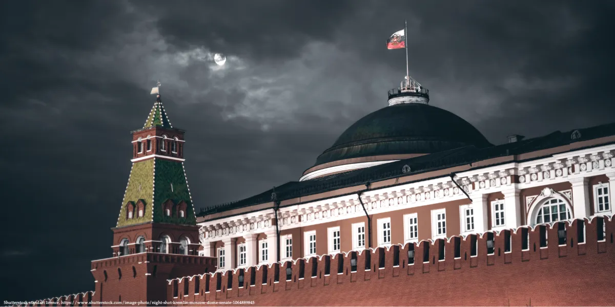 Kremlin buildings under dark storm clouds at night.